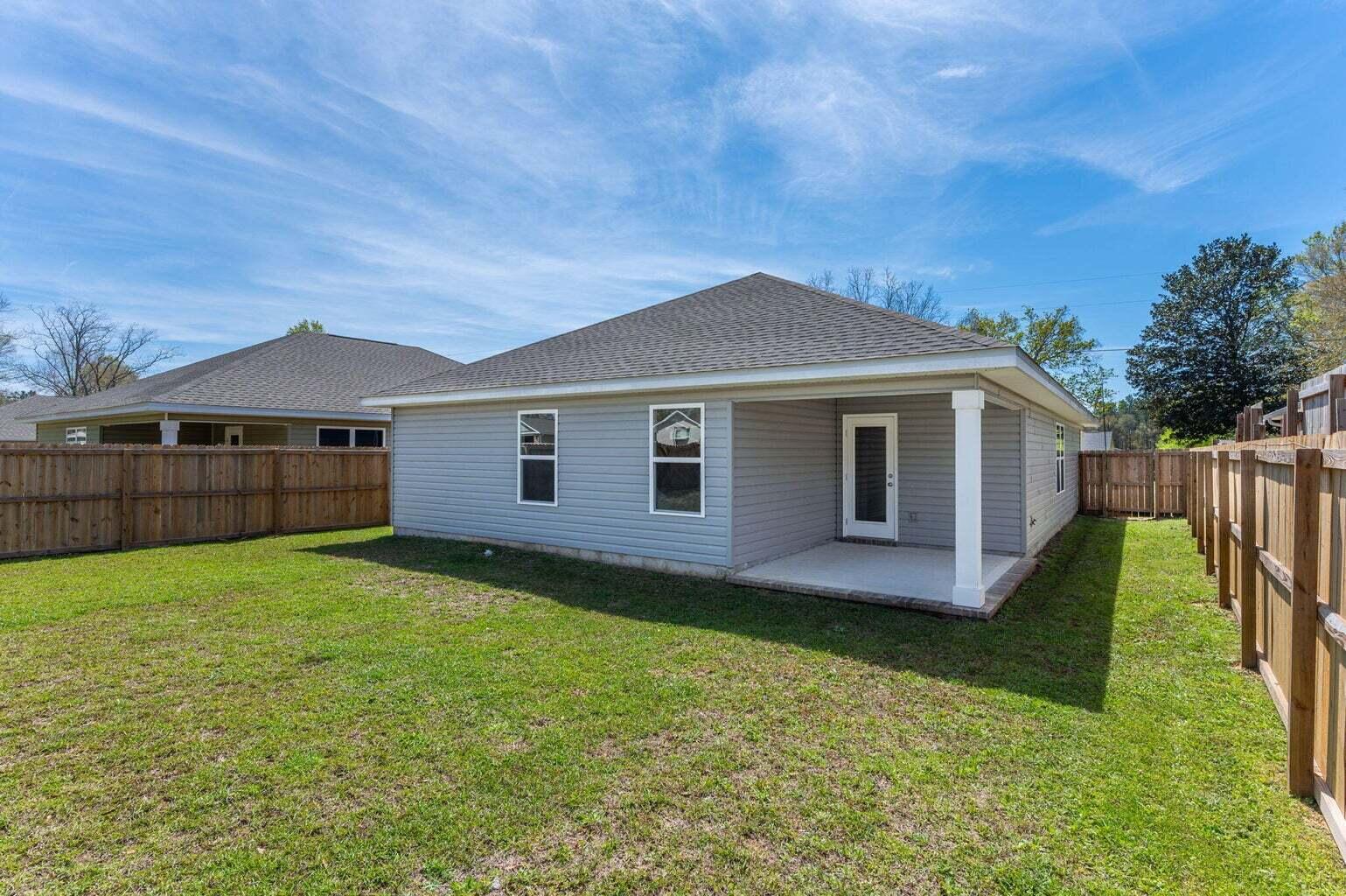 3161 Haskell Langley Road Crestview, FL 32539 - Photo 33 of 36 a view of a yard in front of a house with wooden fence