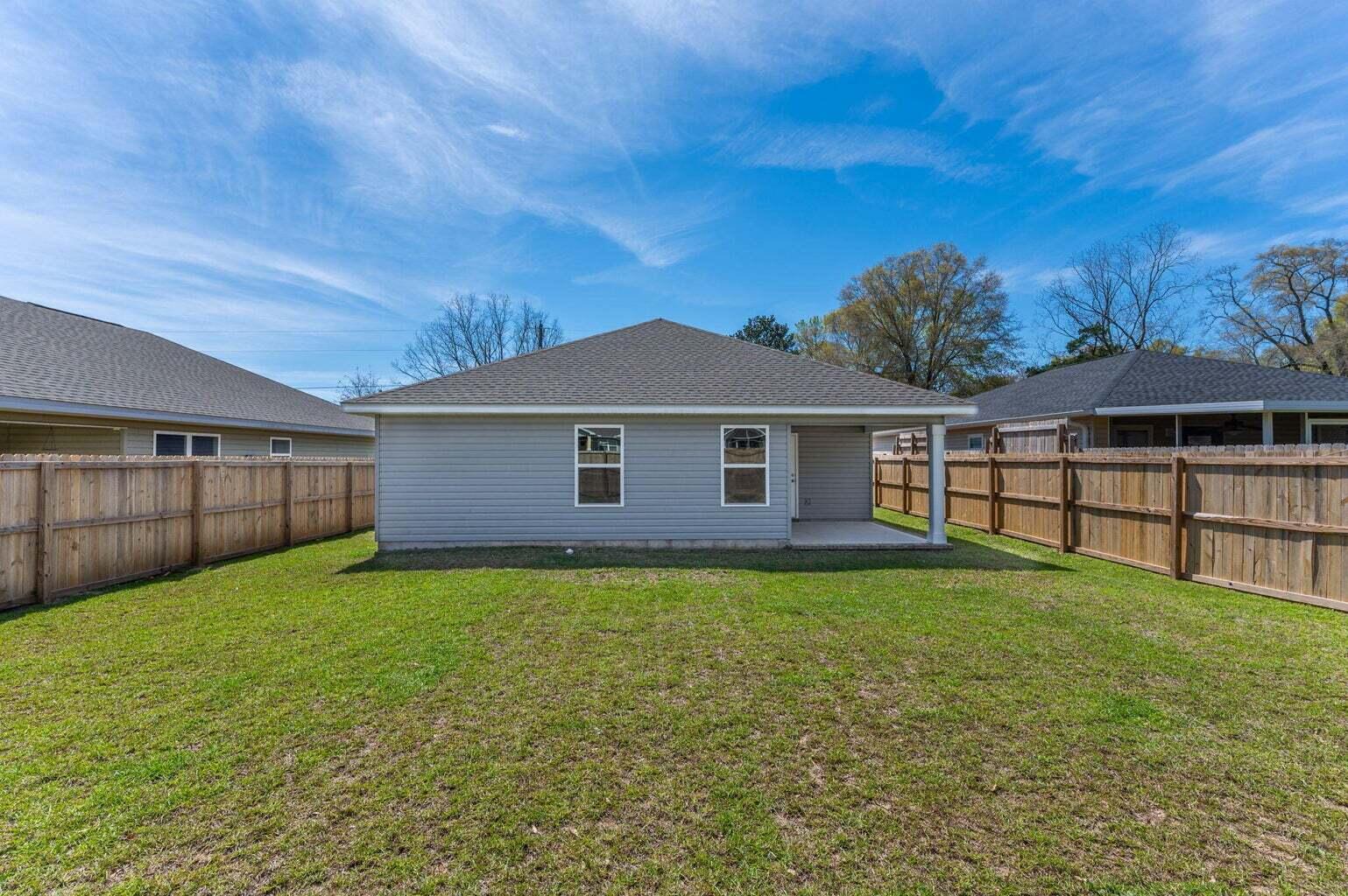 3161 Haskell Langley Road Crestview, FL 32539 - Photo 34 of 36 a view of a yard in front of a house with large trees