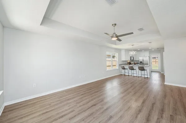 a view of a livingroom with furniture and a ceiling fan
