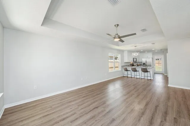 a view of a livingroom with furniture and a ceiling fan