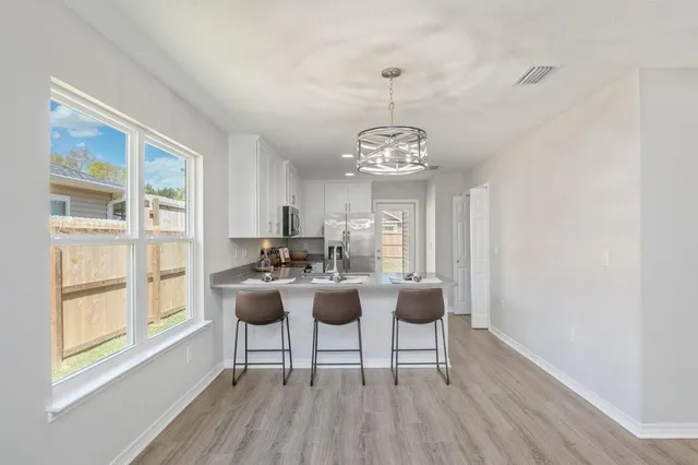 a view of a livingroom with furniture window and wooden floor