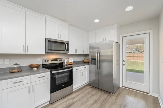 a kitchen with a refrigerator stove and microwave