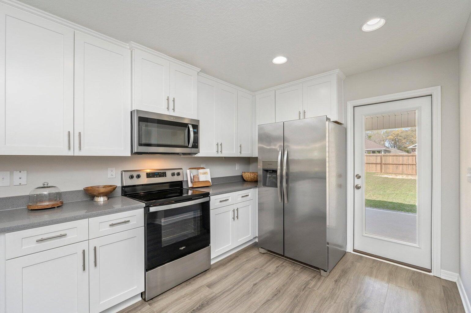 3161 Haskell Langley Road Crestview, FL 32539 - Photo 9 of 36 a kitchen with a refrigerator stove and microwave