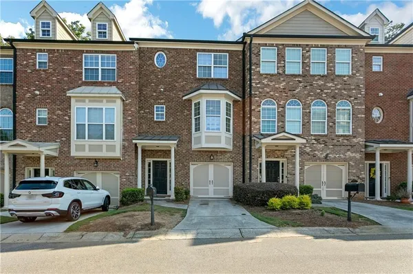 a front view of a residential apartment building with a yard