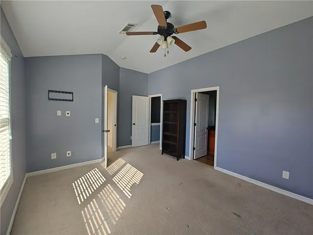 a view of a livingroom with a ceiling fan window and a ceiling fan
