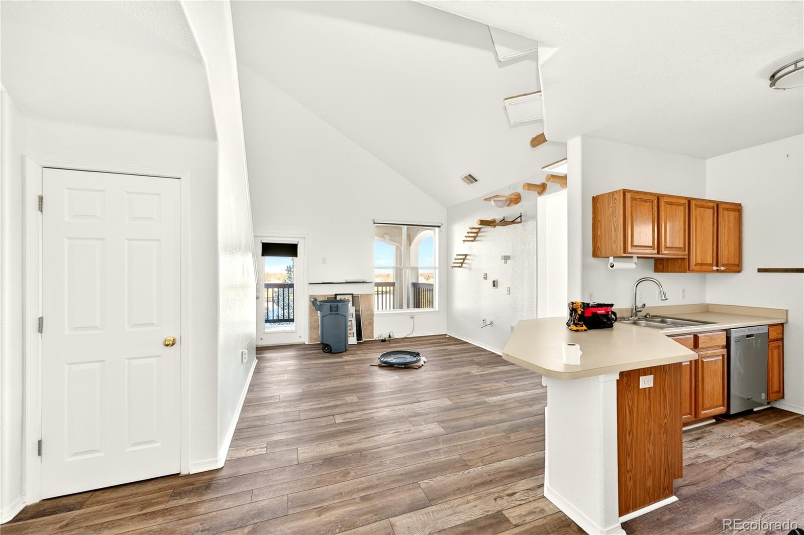 18929 East Warren Circle, Unit C205 Aurora, CO 80013 - Photo 14 of 46 a open kitchen with stainless steel appliances granite countertop a sink stove and refrigerator