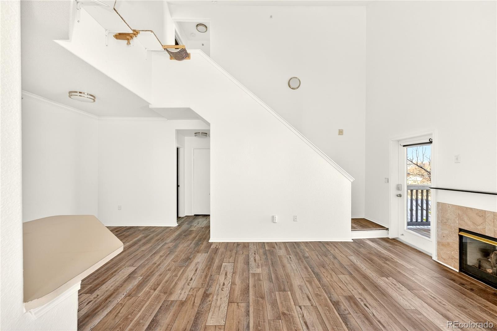 18929 East Warren Circle, Unit C205 Aurora, CO 80013 - Photo 15 of 46 a view of a livingroom with wooden floor and staircase