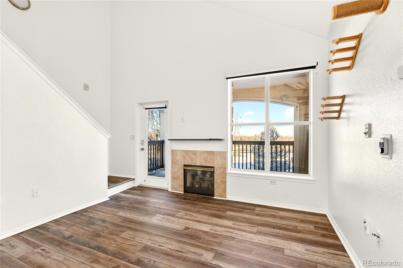 18929 East Warren Circle, Unit C205 Aurora, CO 80013 - Photo 17 of 46 a view of an empty room with a window and fireplace