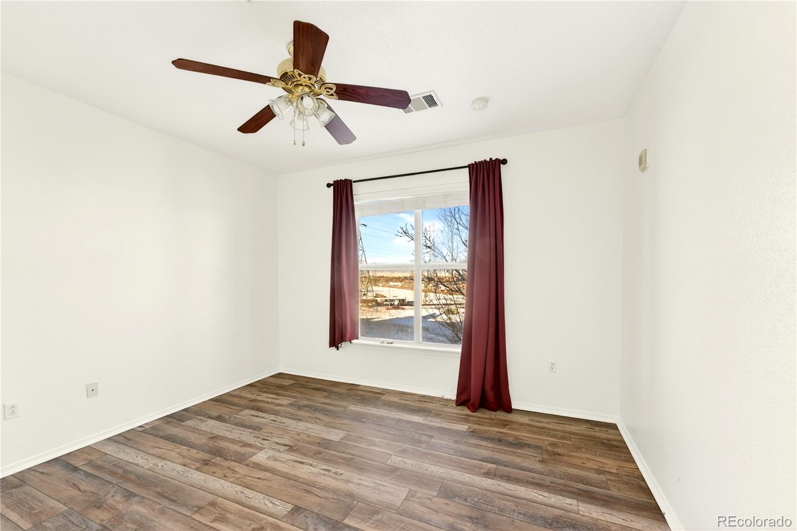 18929 East Warren Circle, Unit C205 Aurora, CO 80013 - Photo 25 of 46 a view of empty room with wooden floor