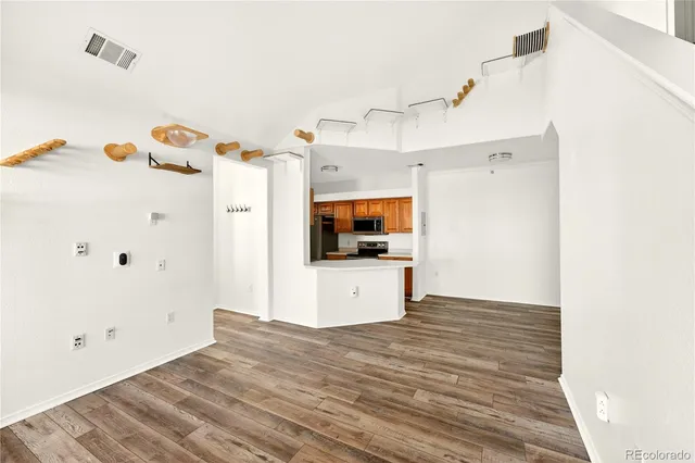 a kitchen with a stove a refrigerator and a microwave