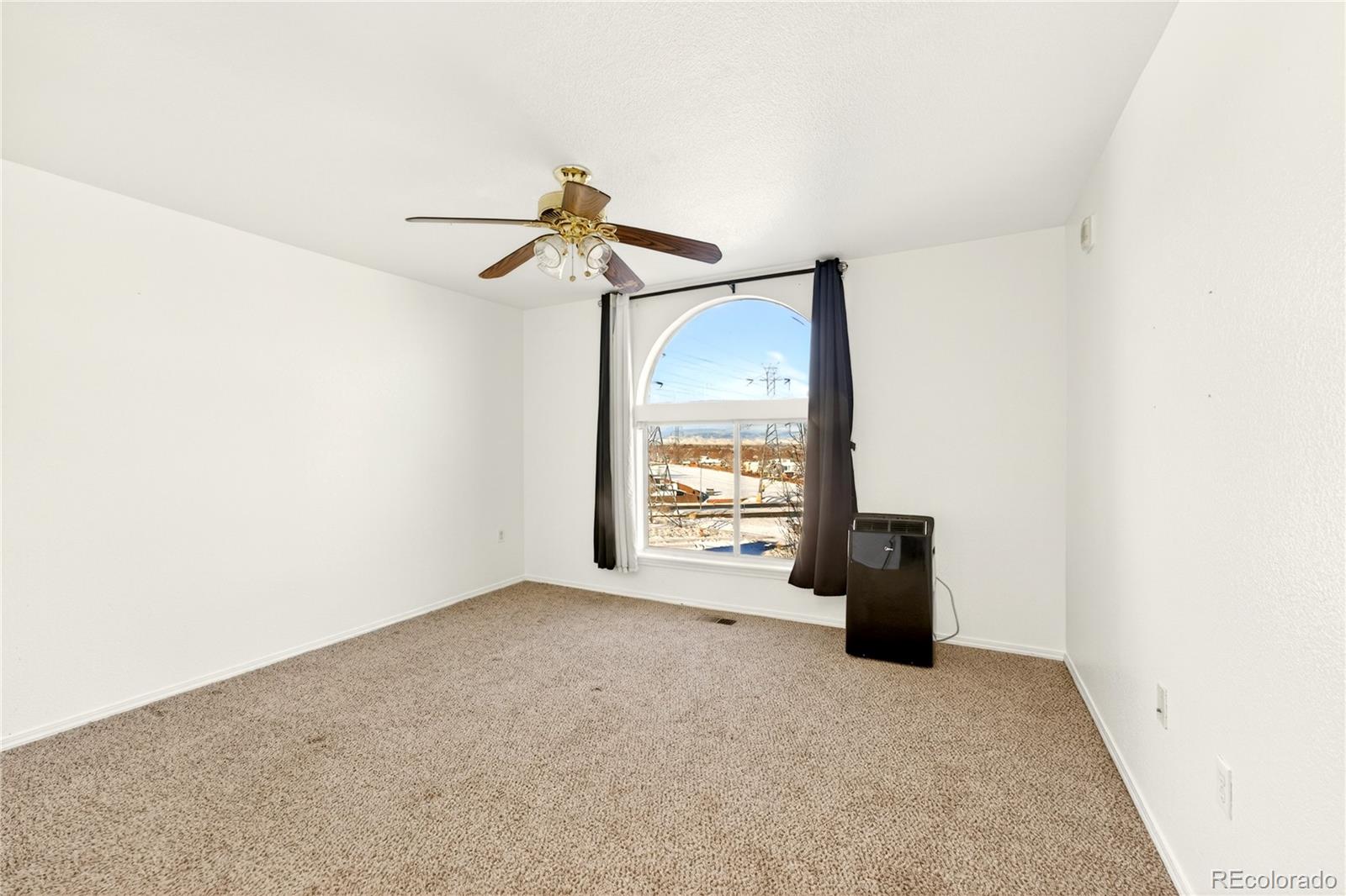 18929 East Warren Circle, Unit C205 Aurora, CO 80013 - Photo 29 of 46 a view of an empty room with a window