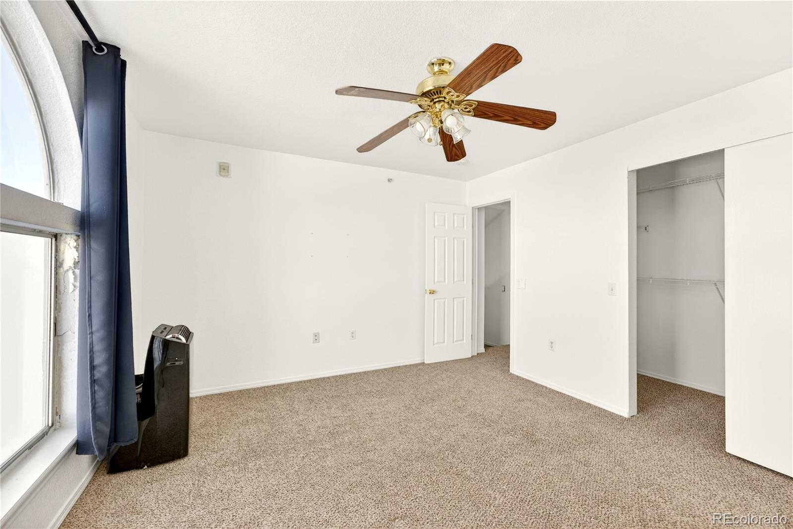 18929 East Warren Circle, Unit C205 Aurora, CO 80013 - Photo 30 of 46 a view of a livingroom with a ceiling fan and window