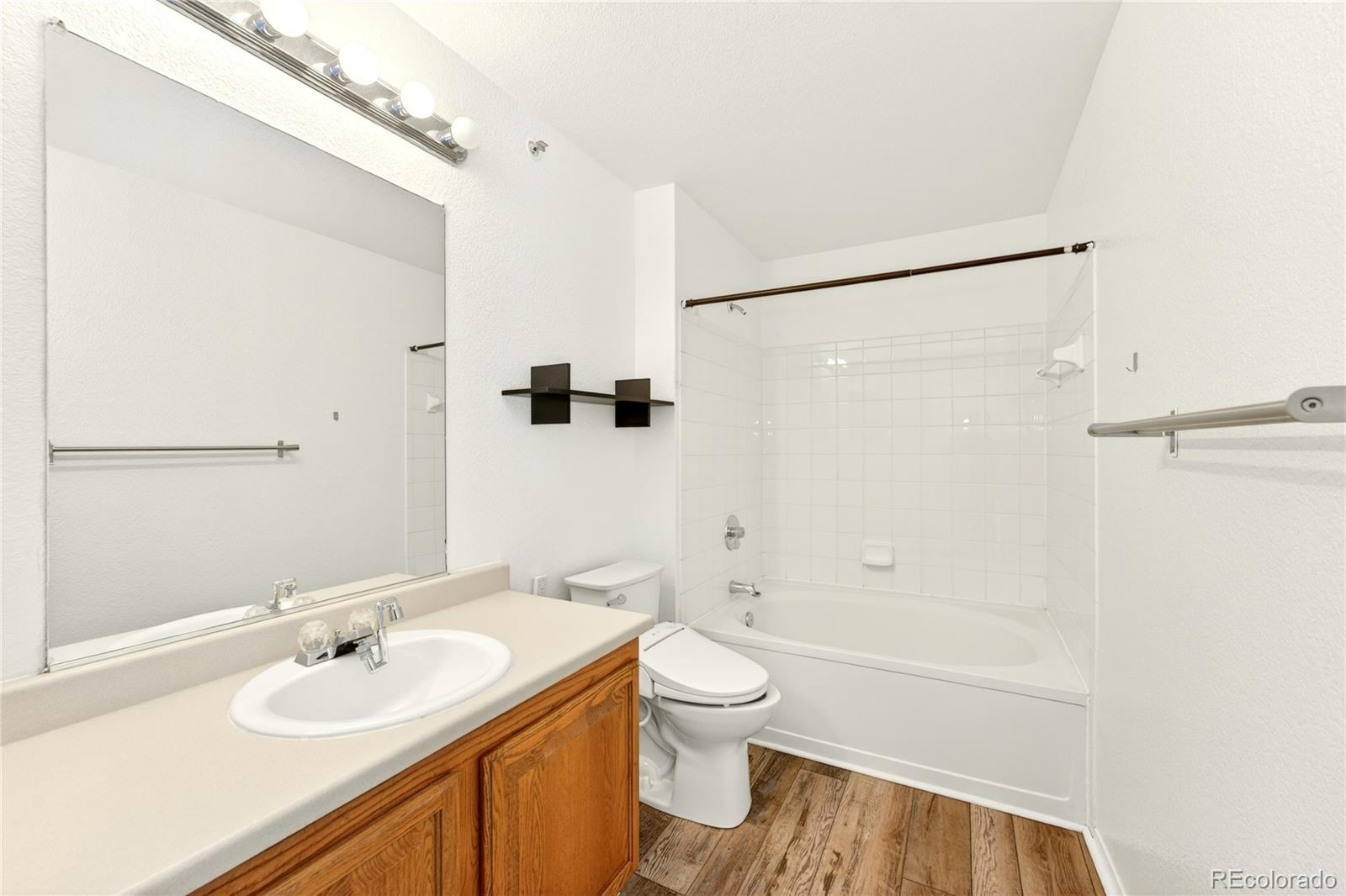 18929 East Warren Circle, Unit C205 Aurora, CO 80013 - Photo 31 of 46 a bathroom with a sink a toilet and shower