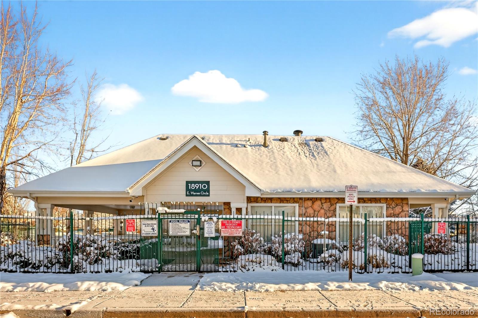 18929 East Warren Circle, Unit C205 Aurora, CO 80013 - Photo 35 of 46 a view of a white house next to a yard with potted plants