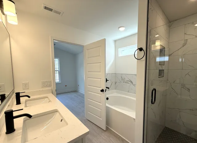 a bathroom with a bathtub and a sink