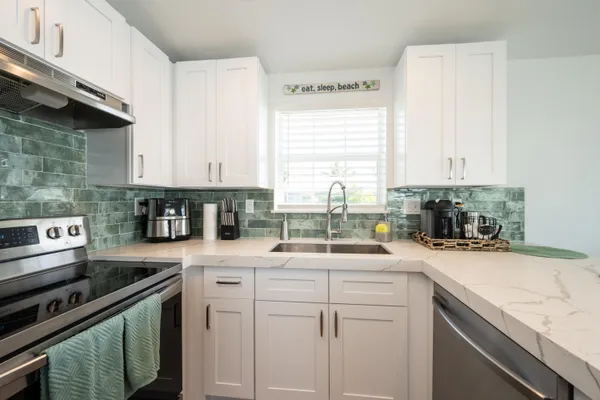 a bathroom with a granite countertop toilet and a shower