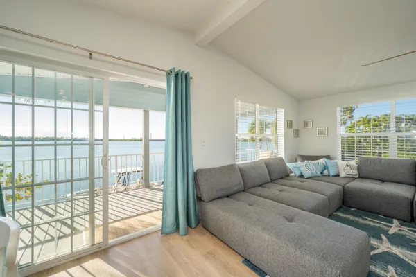 a view of balcony with wooden floor outdoor seating and stairs