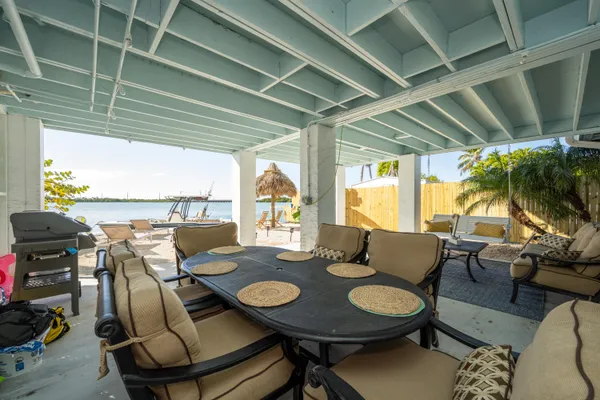 a living room with furniture and floor to ceiling windows