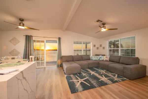 a bedroom with a bed and a flat tv screen on dresser