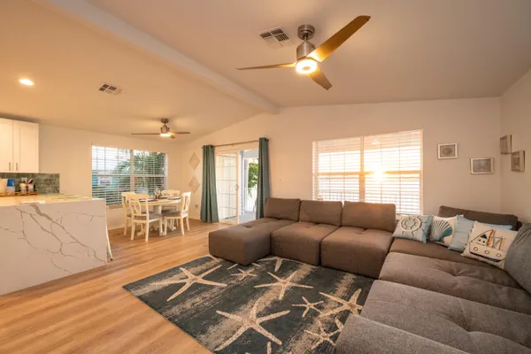 a bedroom with a bed wooden floor and a flat screen tv