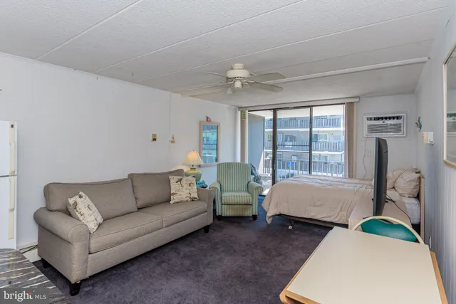 a spacious bedroom with a bed couch and window