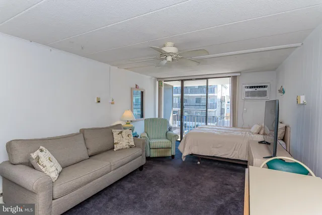 a bedroom with a bed couch and window