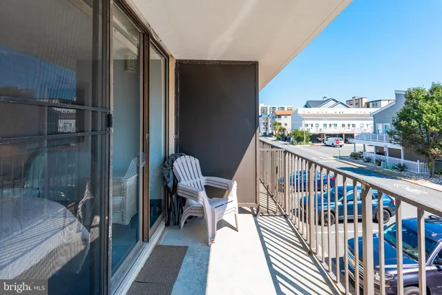 a balcony with chairs and a table