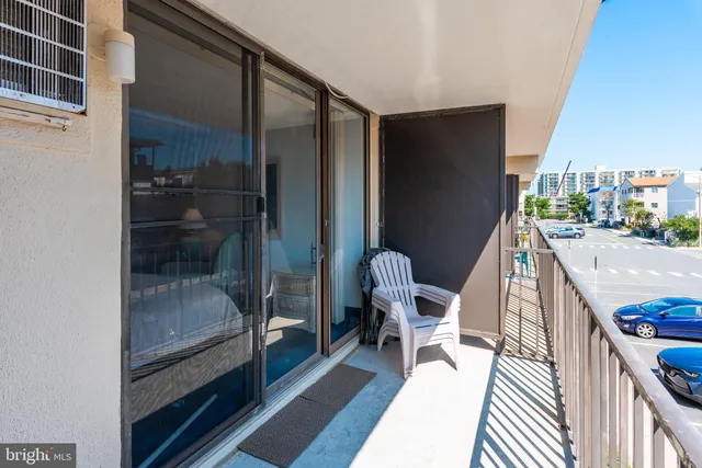 a balcony view with a glass door shower and sink