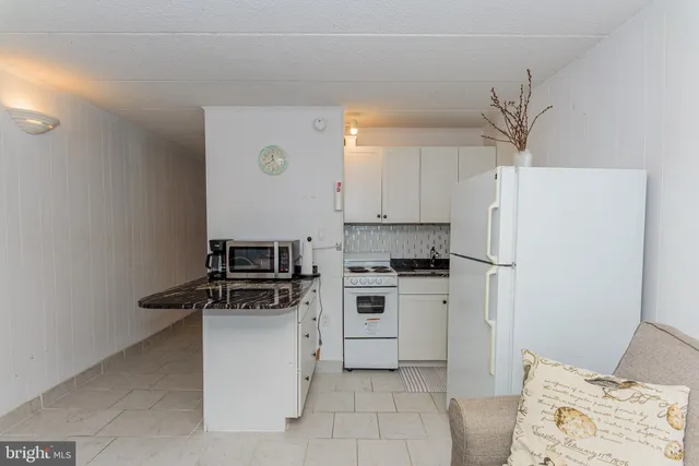 a kitchen with a refrigerator a stove top oven a sink and dishwasher