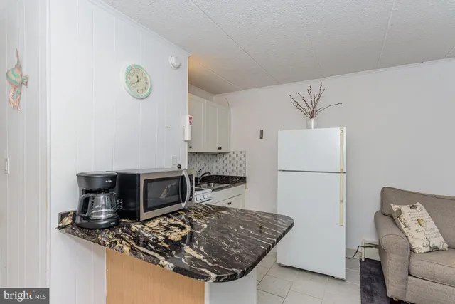 a kitchen with stainless steel appliances granite countertop a stove microwave and a sink