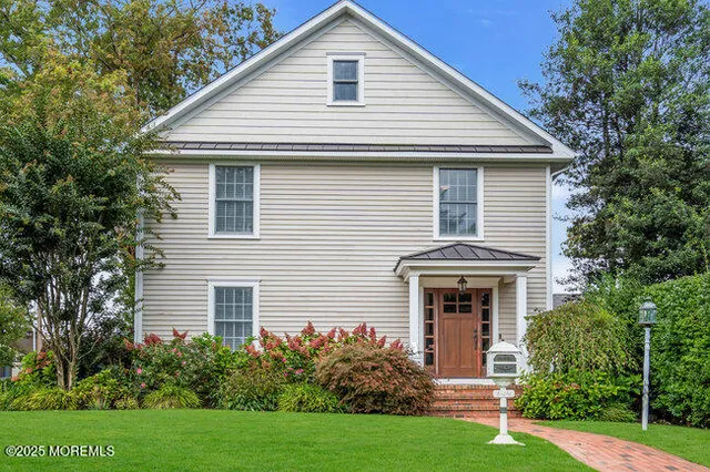 a front view of house with yard and green space