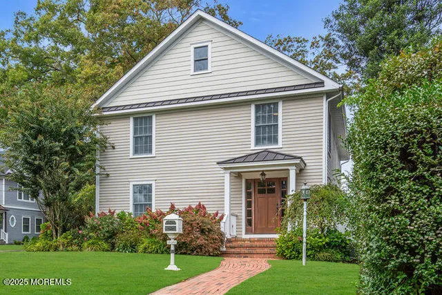 a front view of house with yard and green space