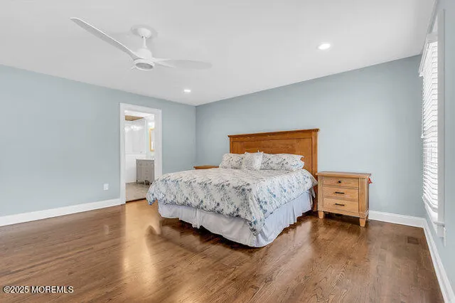 a bathroom with a granite countertop sink mirror vanity and toilet