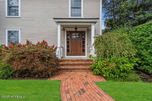 a front view of a house with garden