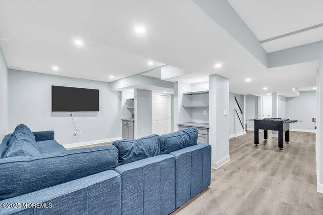 a living room with furniture and kitchen view