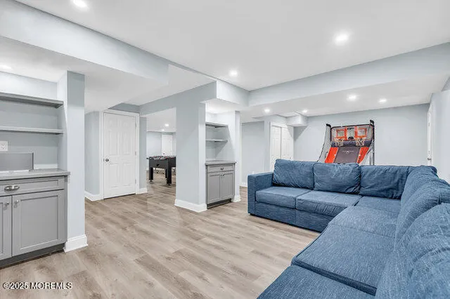 a view of a backyard with table and chairs potted plants and large tree