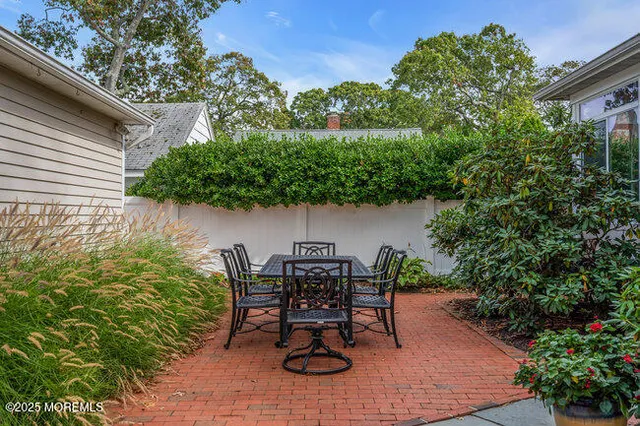 a view of a house with backyard sitting area and garden