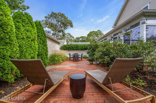 a view of patio with table and chairs and potted plants