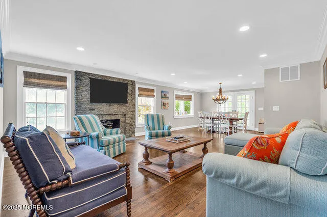 a living room with furniture a flat screen tv and a fireplace