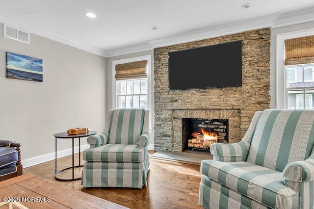 a living room with furniture fireplace and flat screen tv