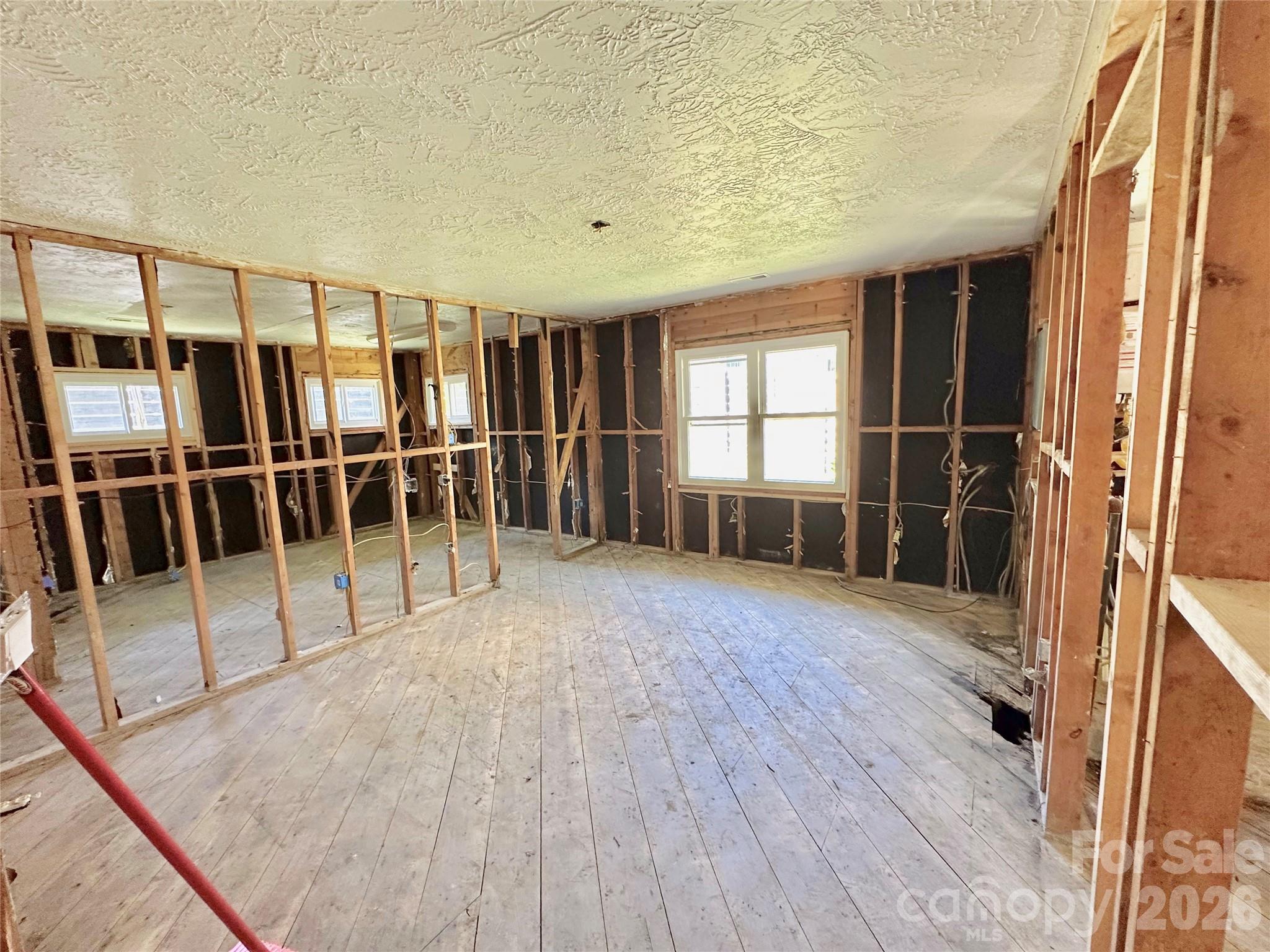 402 Blue Ridge Road Black Mountain, NC 28711 - Photo 8 of 18 a view of empty room with wooden floor and fan