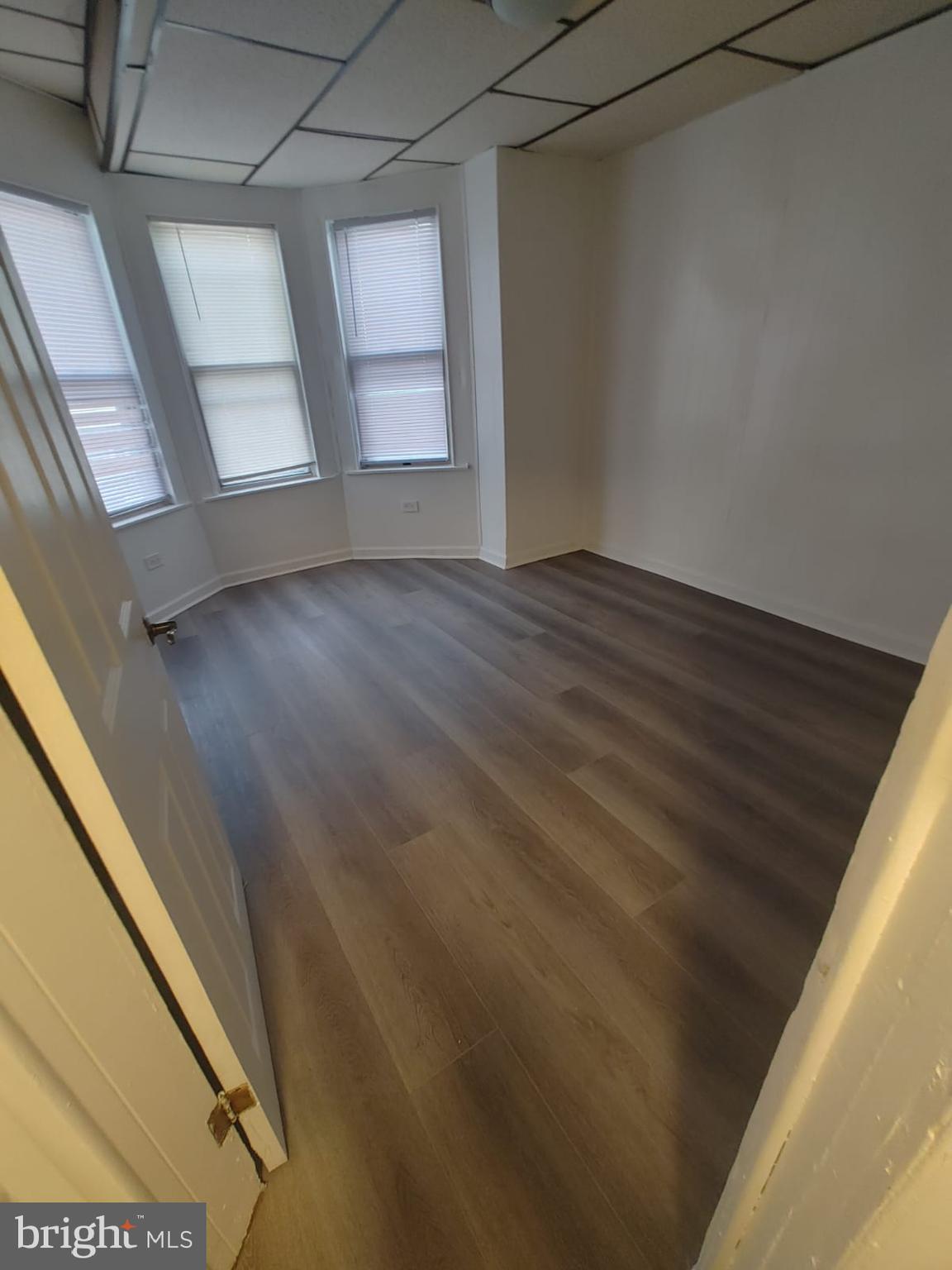 208-210 North Avondale Street Philadelphia, PA 19139 - Photo 11 of 15 a view of empty room with wooden floor and fan