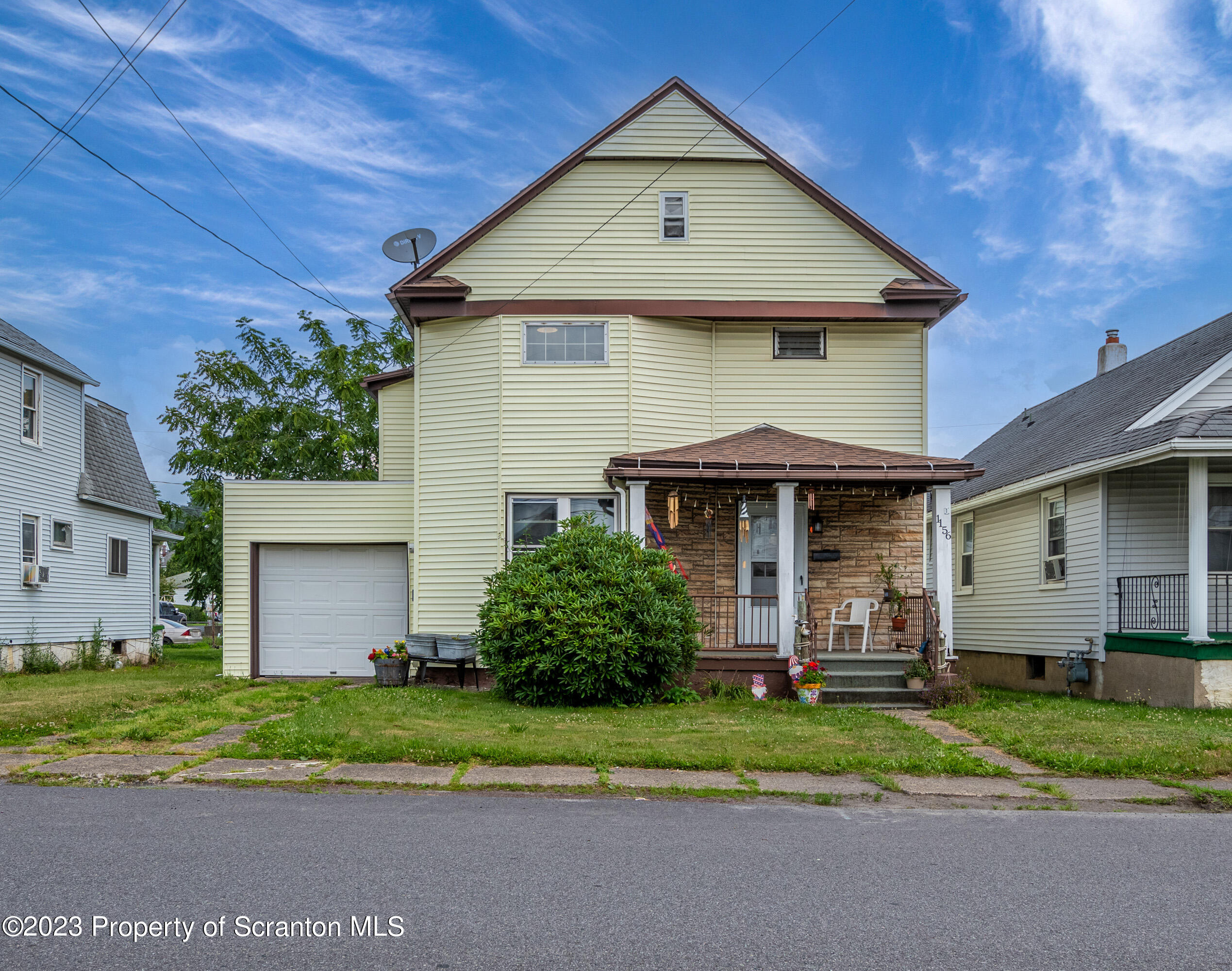 1156 Reynolds Avenue Taylor, PA 18504 - Photo 1 of 31 a front view of a house with a yard and garage