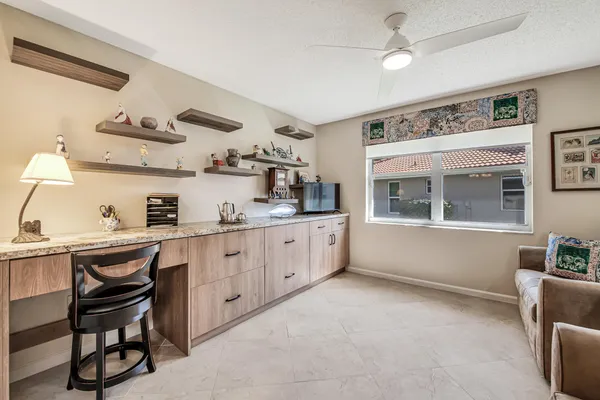 a bathroom with a granite countertop double vanity sink and mirror