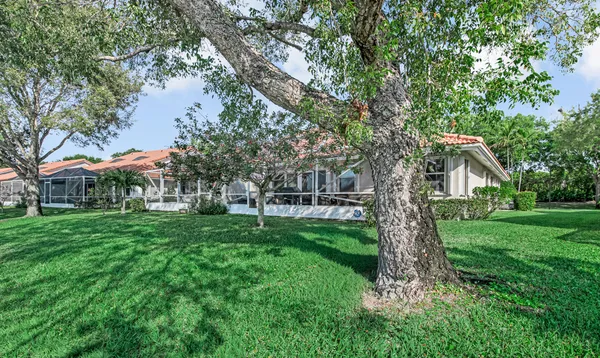 an aerial view of a house with a garden and lake view