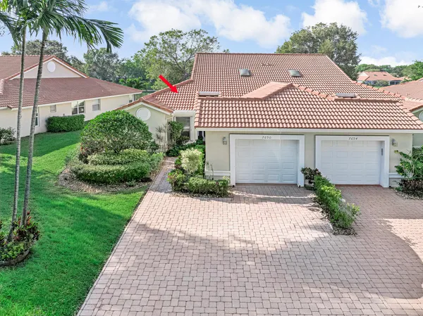 an aerial view of a house with garden space and street view