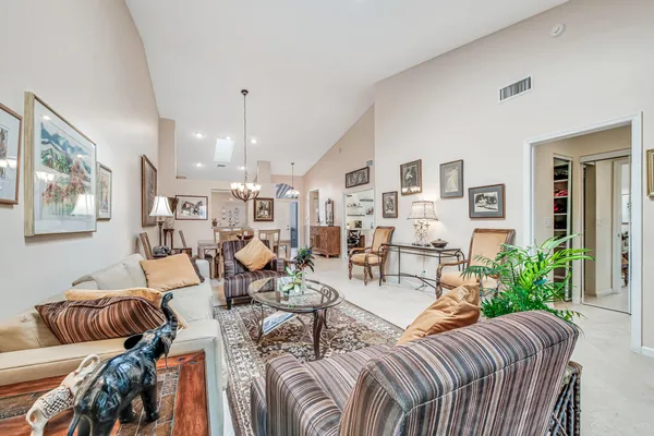 a living room with furniture and a chandelier