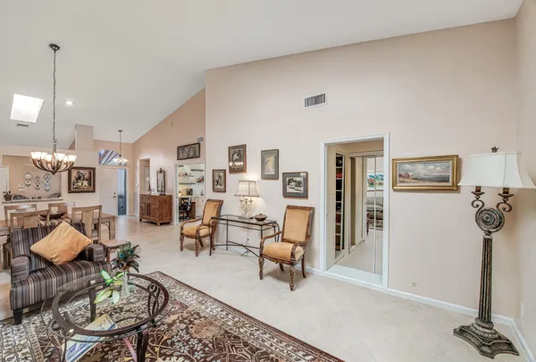 a living room with furniture a rug and white walls
