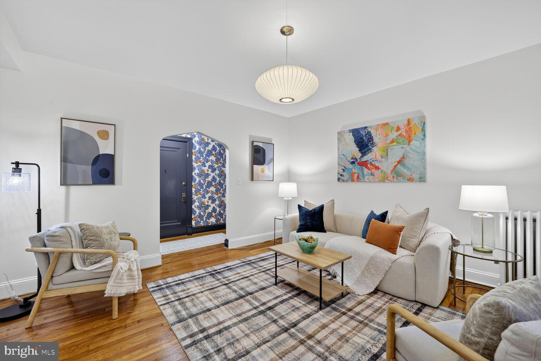 2707 Adams Mill Road Northwest, Unit 303 Washington, DC 20009 - Photo 11 of 27 a living room with furniture and a table
