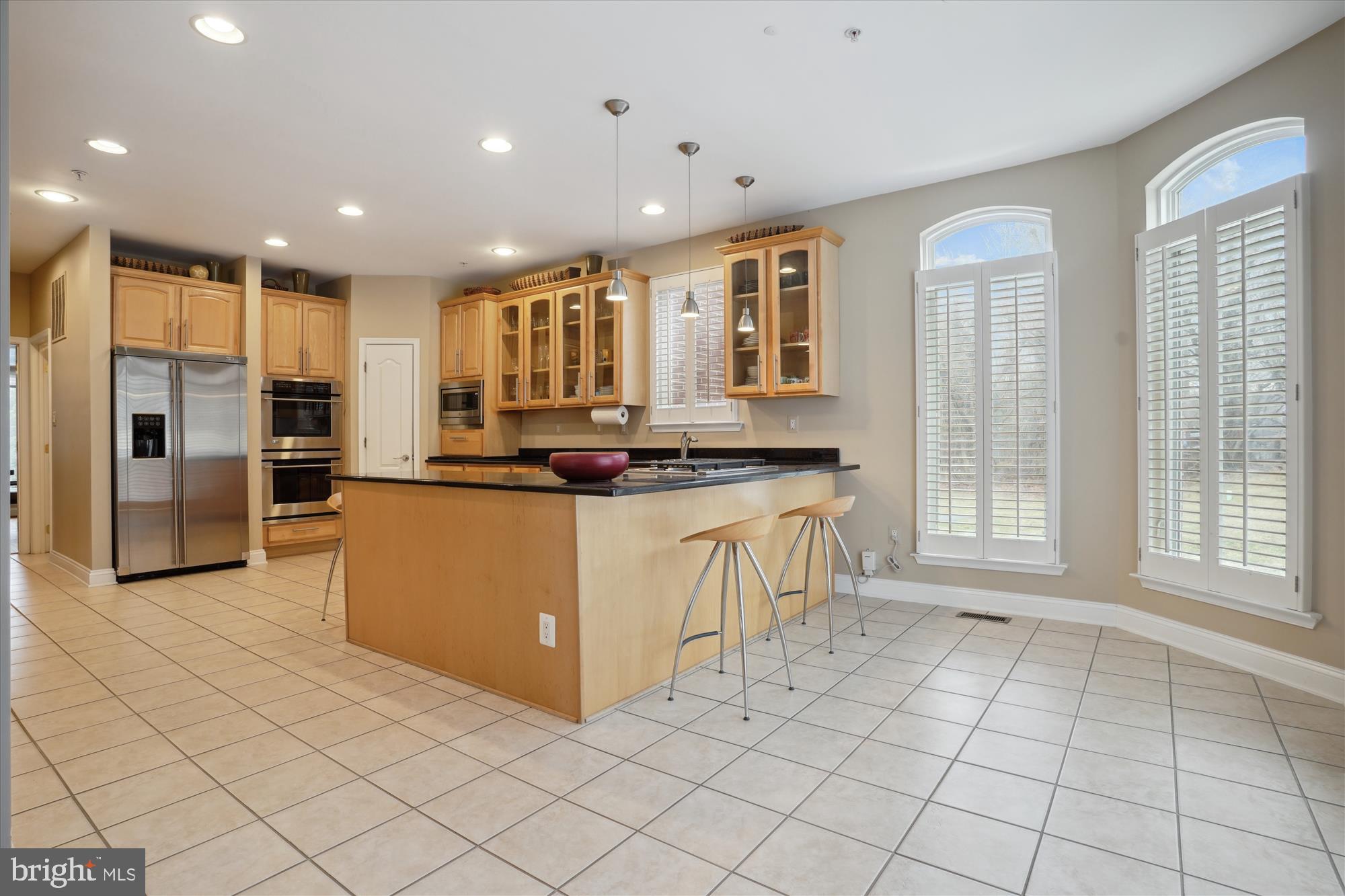 17410 Queen Anne Road Upper Marlboro, MD 20774 - Photo 12 of 82 a kitchen with stainless steel appliances kitchen island granite countertop a stove a sink and a refrigerator